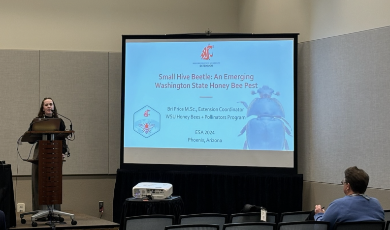 Bri at podium speaking about research 